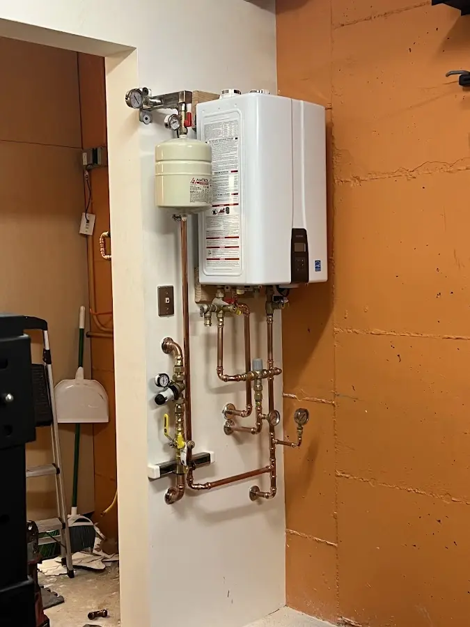 Plumbing technician inspecting water heater connections in Port Charlotte
